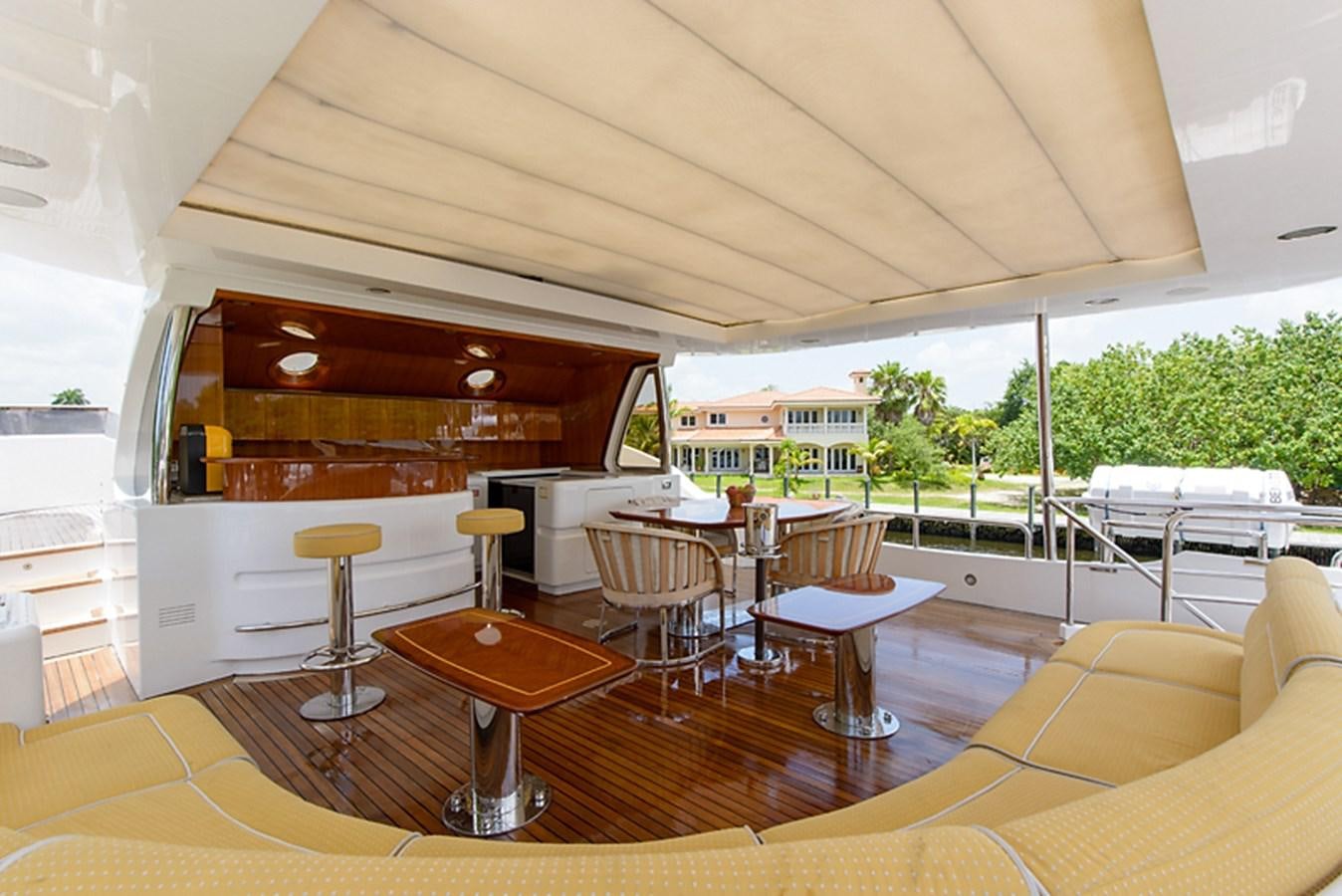 a room with tables and chairs aboard XOXO Yacht for Sale