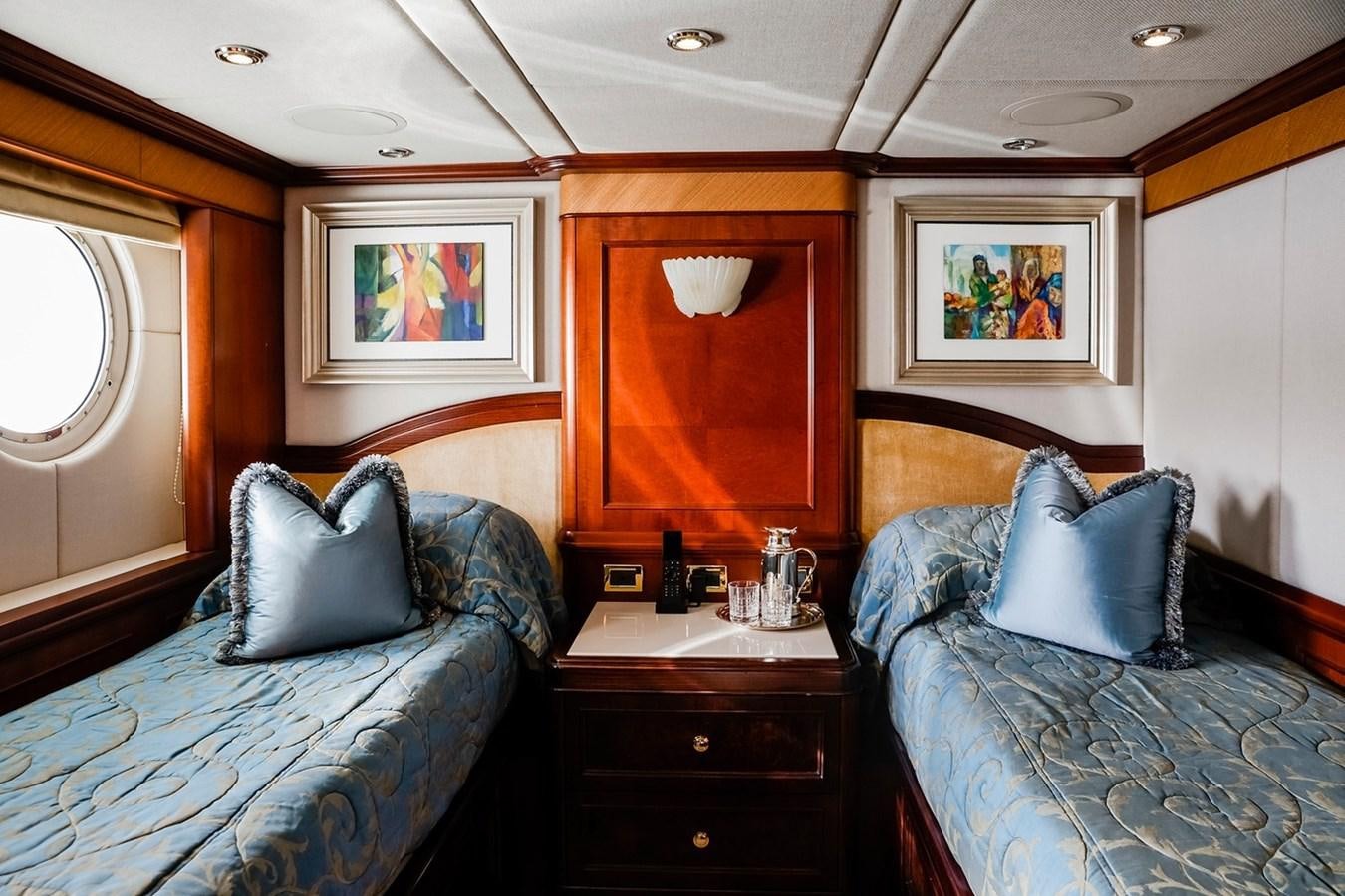 a bedroom with a bed and a desk aboard CRYSTAL LADY Yacht for Sale