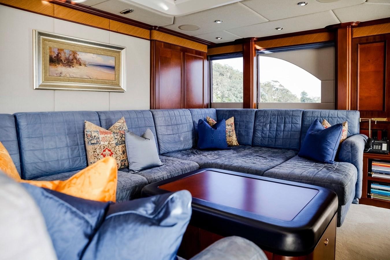 a living room with a blue couch aboard CRYSTAL LADY Yacht for Sale