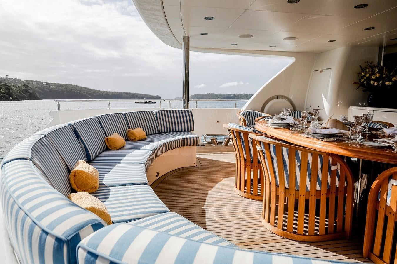 a room with a couch and a table and chairs aboard CRYSTAL LADY Yacht for Sale