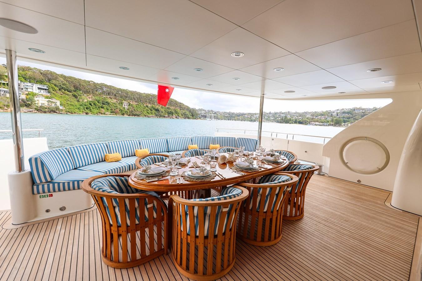 a table set for a meal on a deck aboard CRYSTAL LADY Yacht for Sale