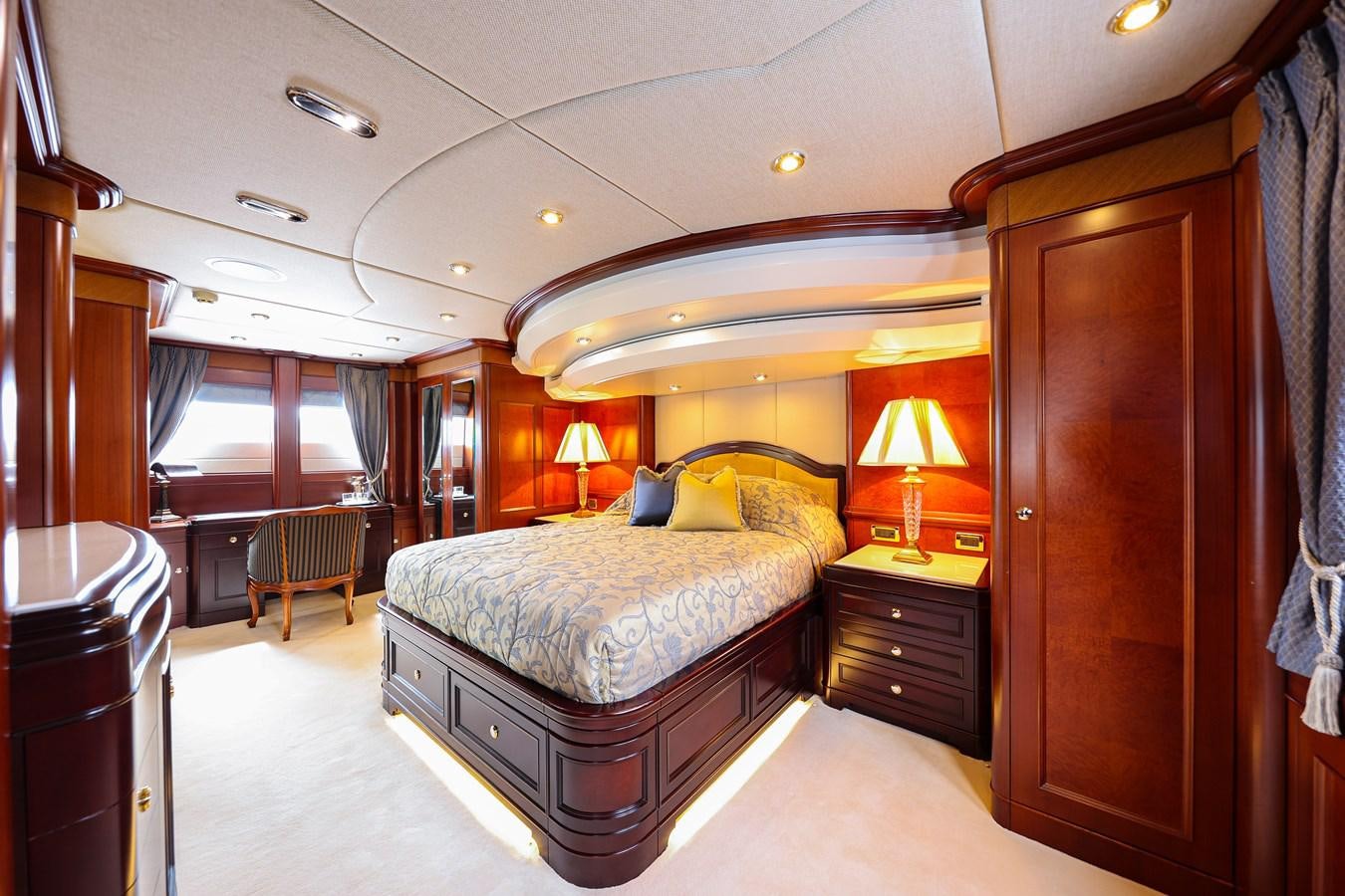 a bedroom with a bed and a desk aboard CRYSTAL LADY Yacht for Sale