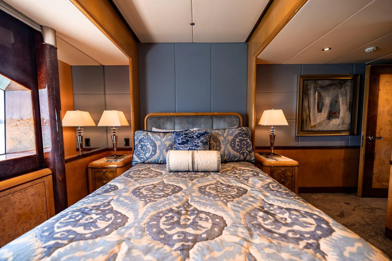 a bed with a blue comforter aboard ELIS ET MAR Yacht for Sale