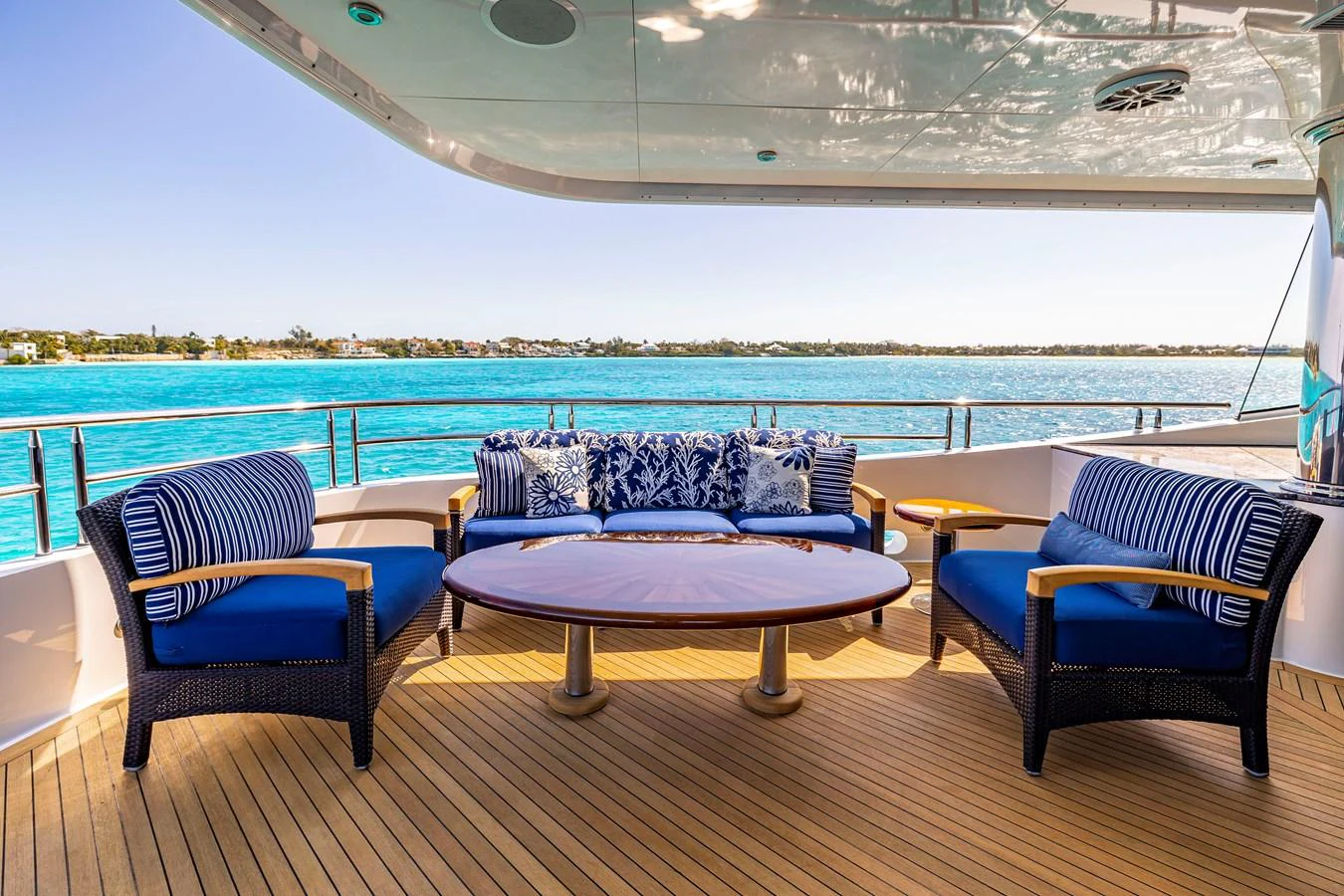 a couple of blue chairs on a balcony overlooking a body of water aboard ELIS ET MAR Yacht for Sale
