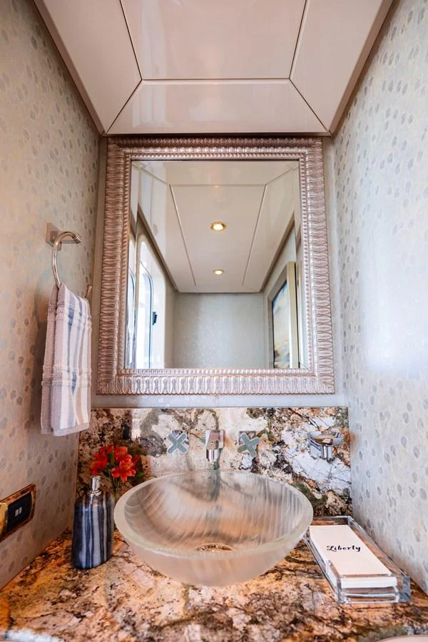 a bathroom with a round mirror aboard ELIS ET MAR Yacht for Sale
