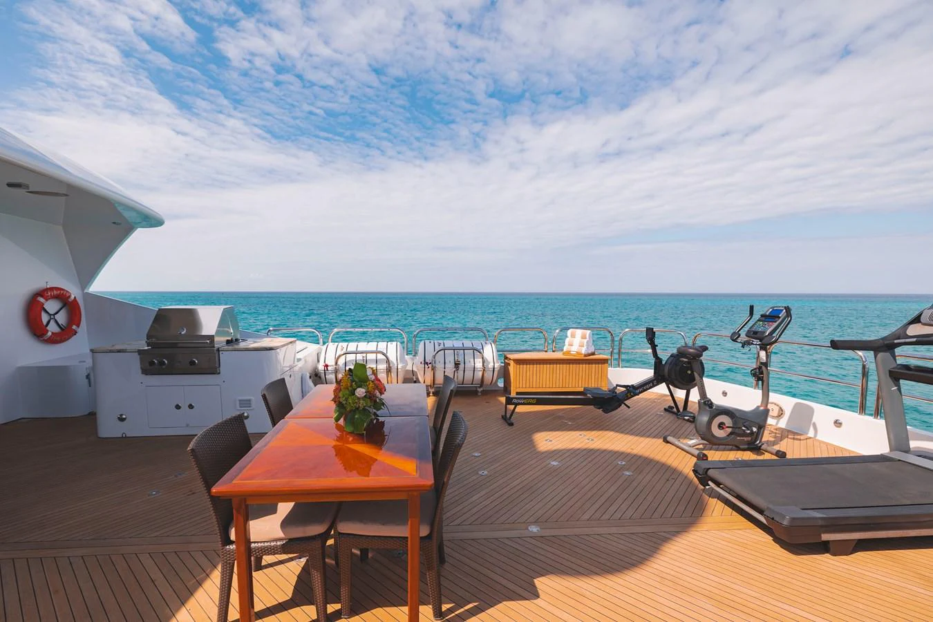 a deck with a table and chairs on it and a body of water in the background aboard ELIS ET MAR Yacht for Sale