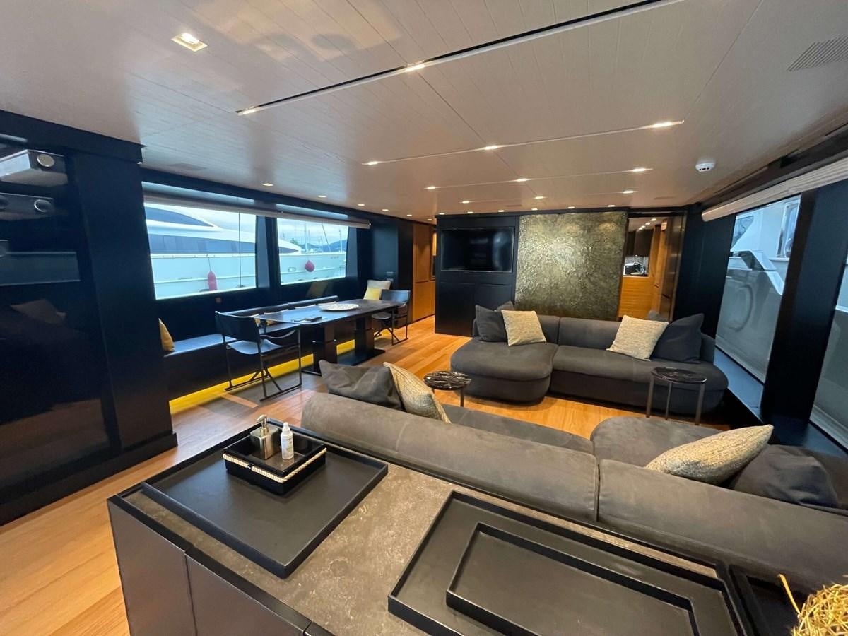 a living room with a large screen aboard REINE D'AZUR Yacht for Sale