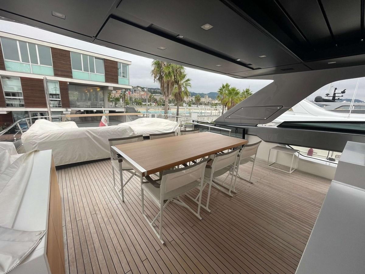 a deck with a table and chairs aboard REINE D'AZUR Yacht for Sale