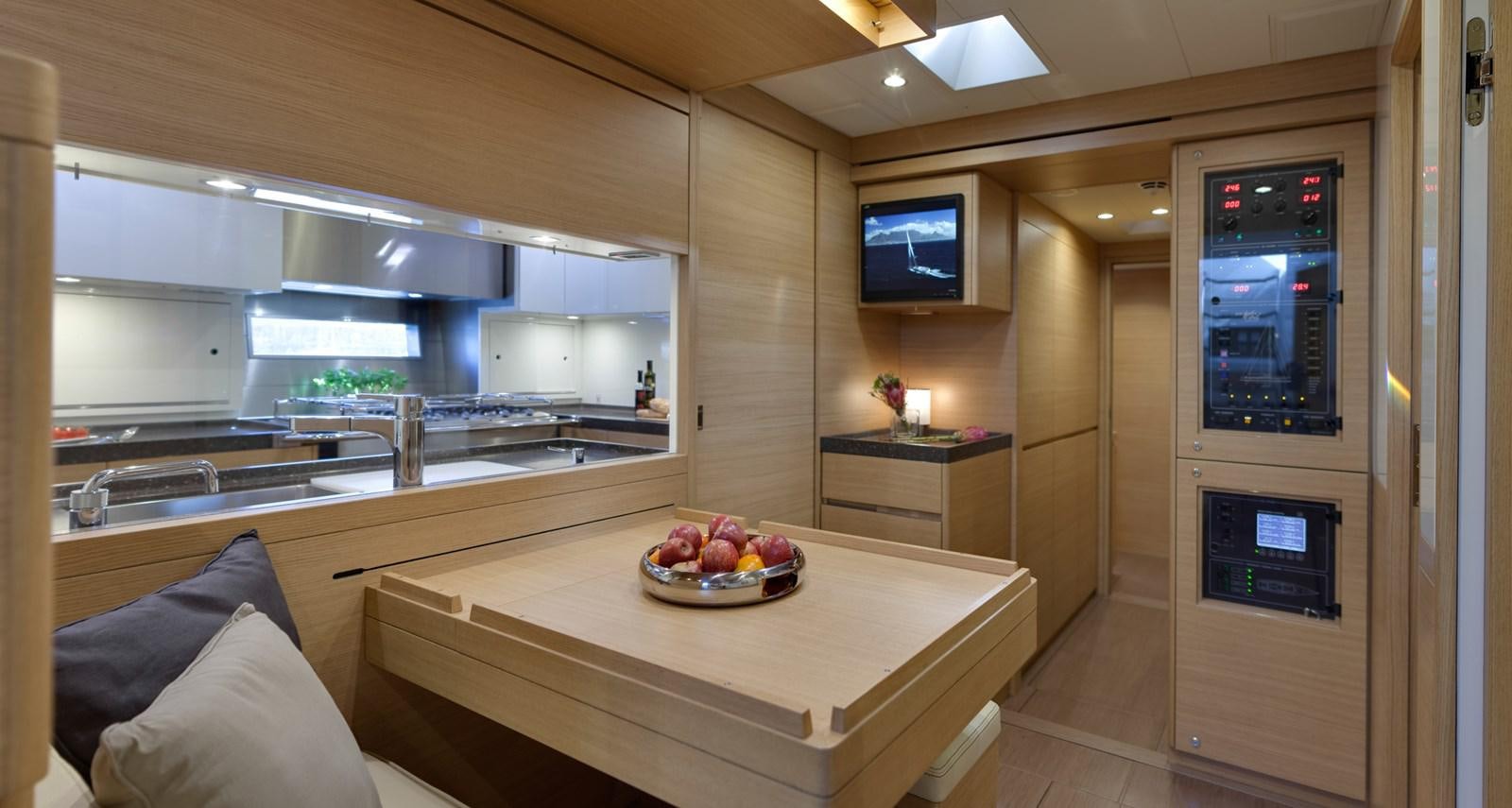 a kitchen with a large counter and a tv on the wall aboard CROSSBOW Yacht for Sale