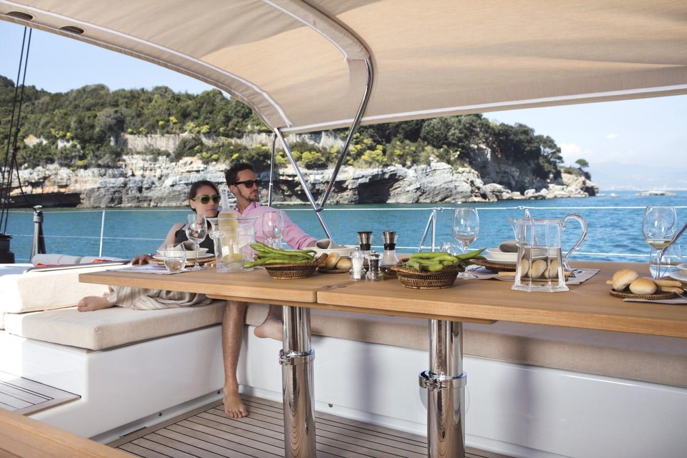 a group of people sitting at a table aboard CROSSBOW Yacht for Sale