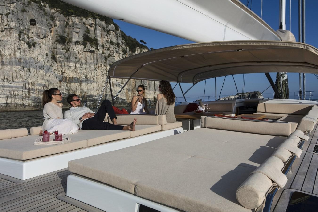 a group of people sitting on a couch aboard CROSSBOW Yacht for Sale