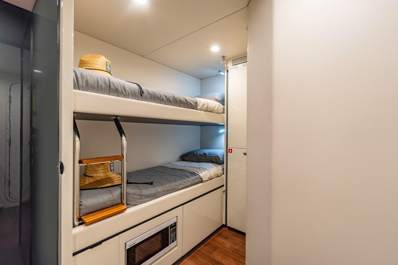 a room with a bed and a chair aboard BIG MAMA Yacht for Sale