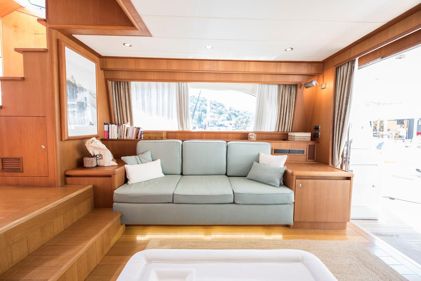 a living room with a couch and a window aboard ITACATOO Yacht for Sale