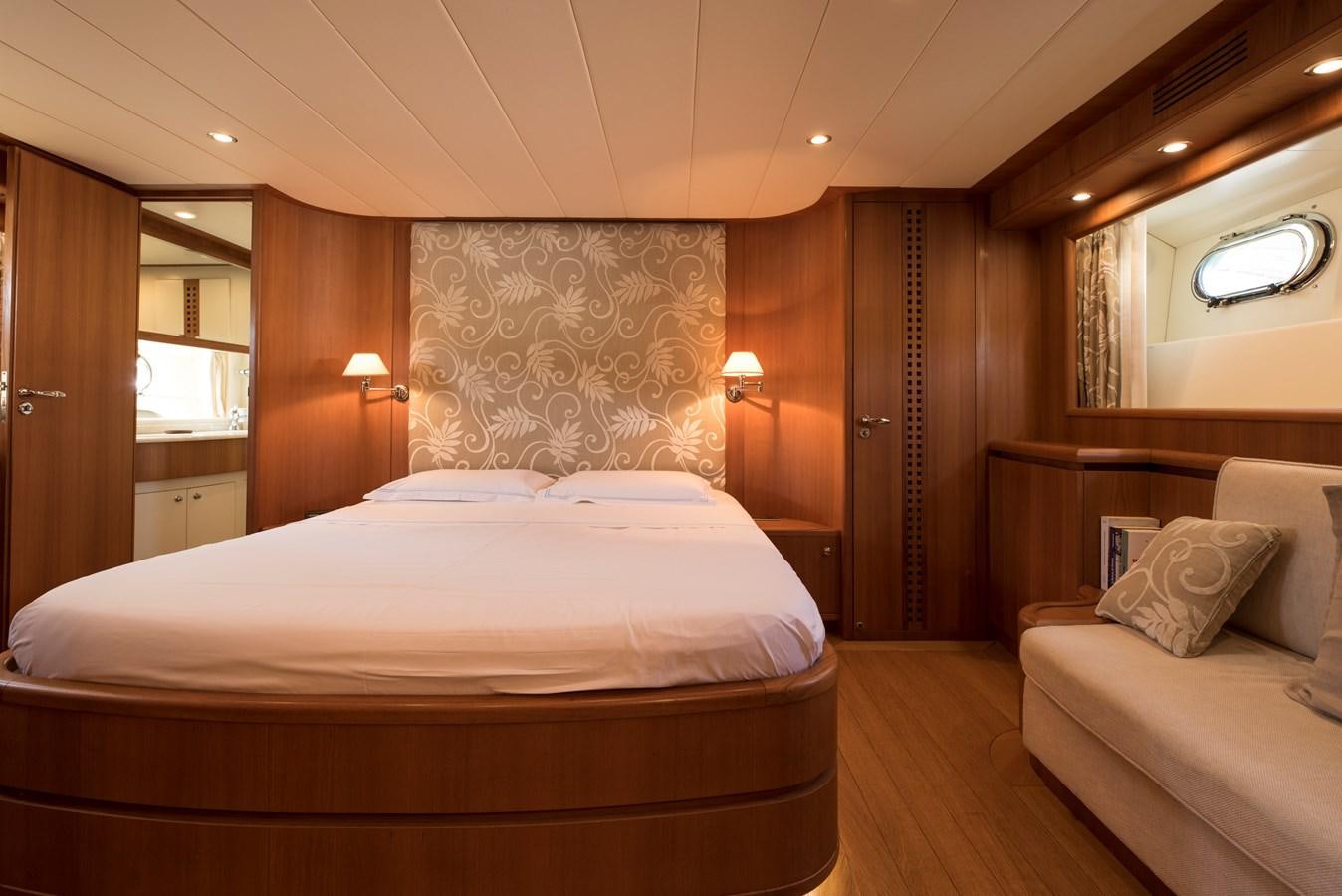 a bedroom with a bed and a couch aboard ITACATOO Yacht for Sale