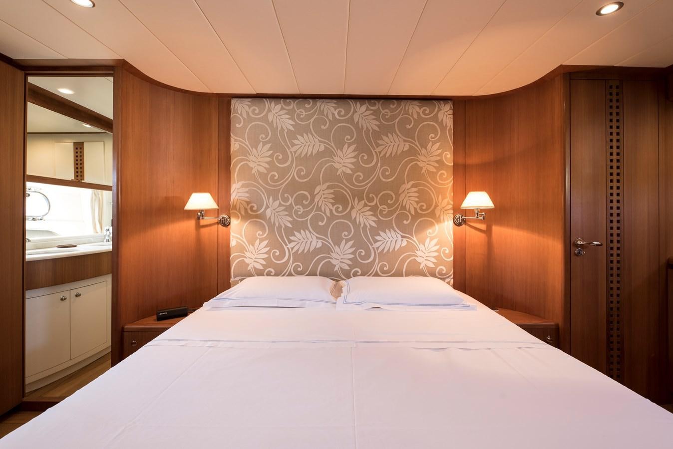 a bed with a white sheet aboard ITACATOO Yacht for Sale
