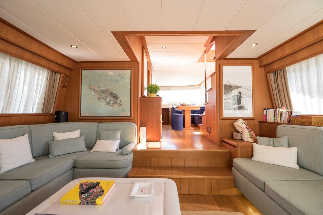 a living room with a couch and a coffee table aboard ITACATOO Yacht for Sale