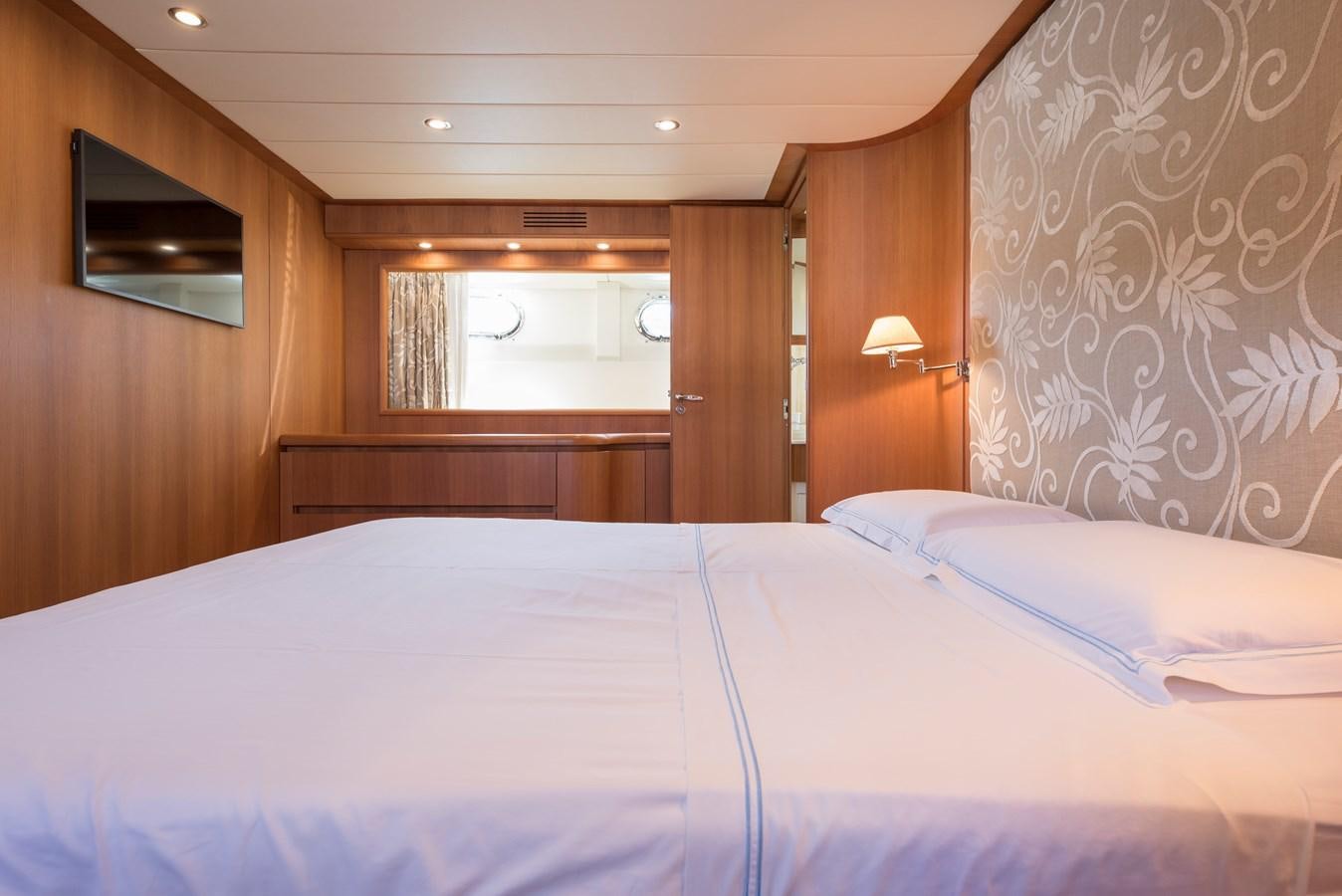 a bed with white sheets aboard ITACATOO Yacht for Sale