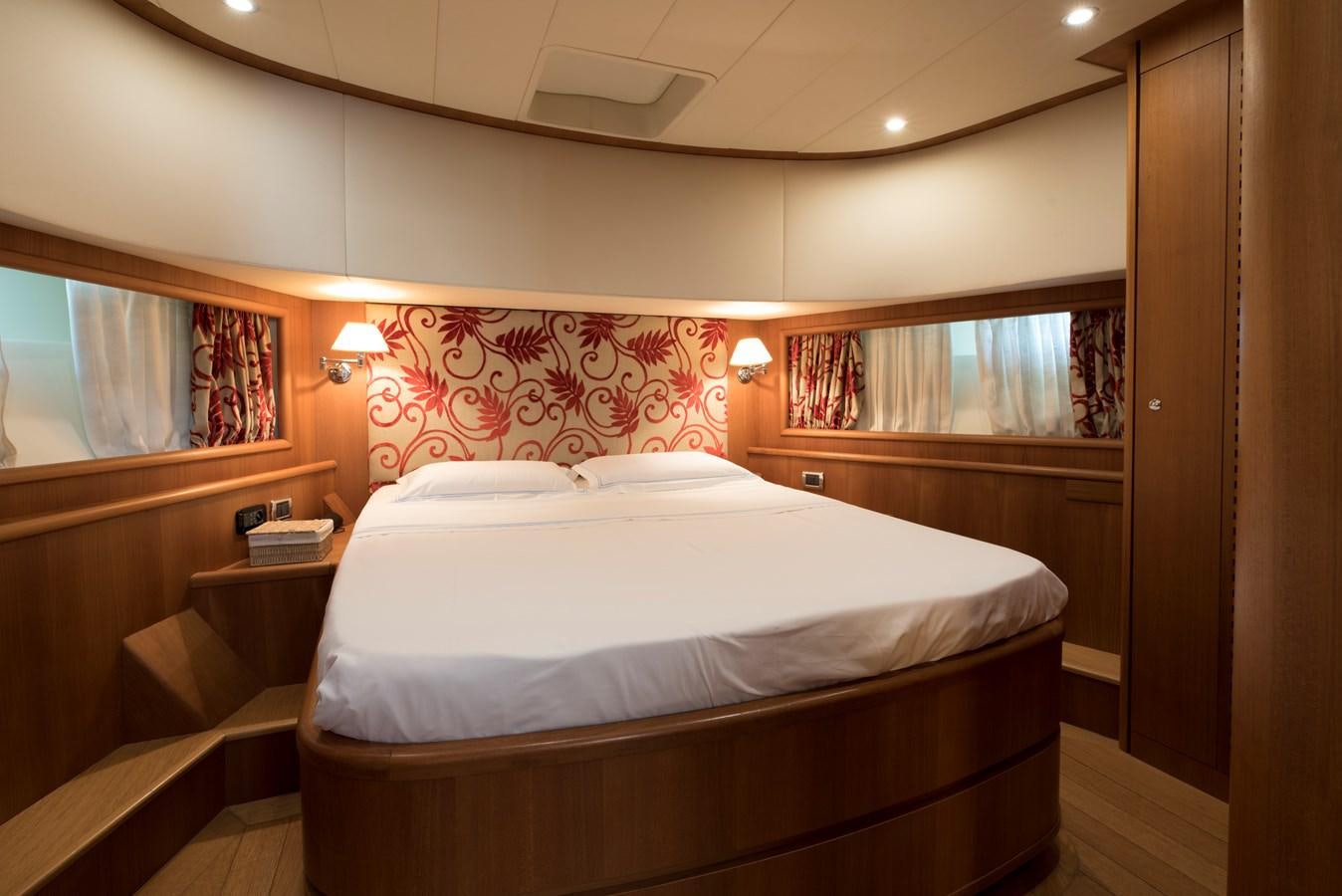 a bedroom with a bed and a desk aboard ITACATOO Yacht for Sale