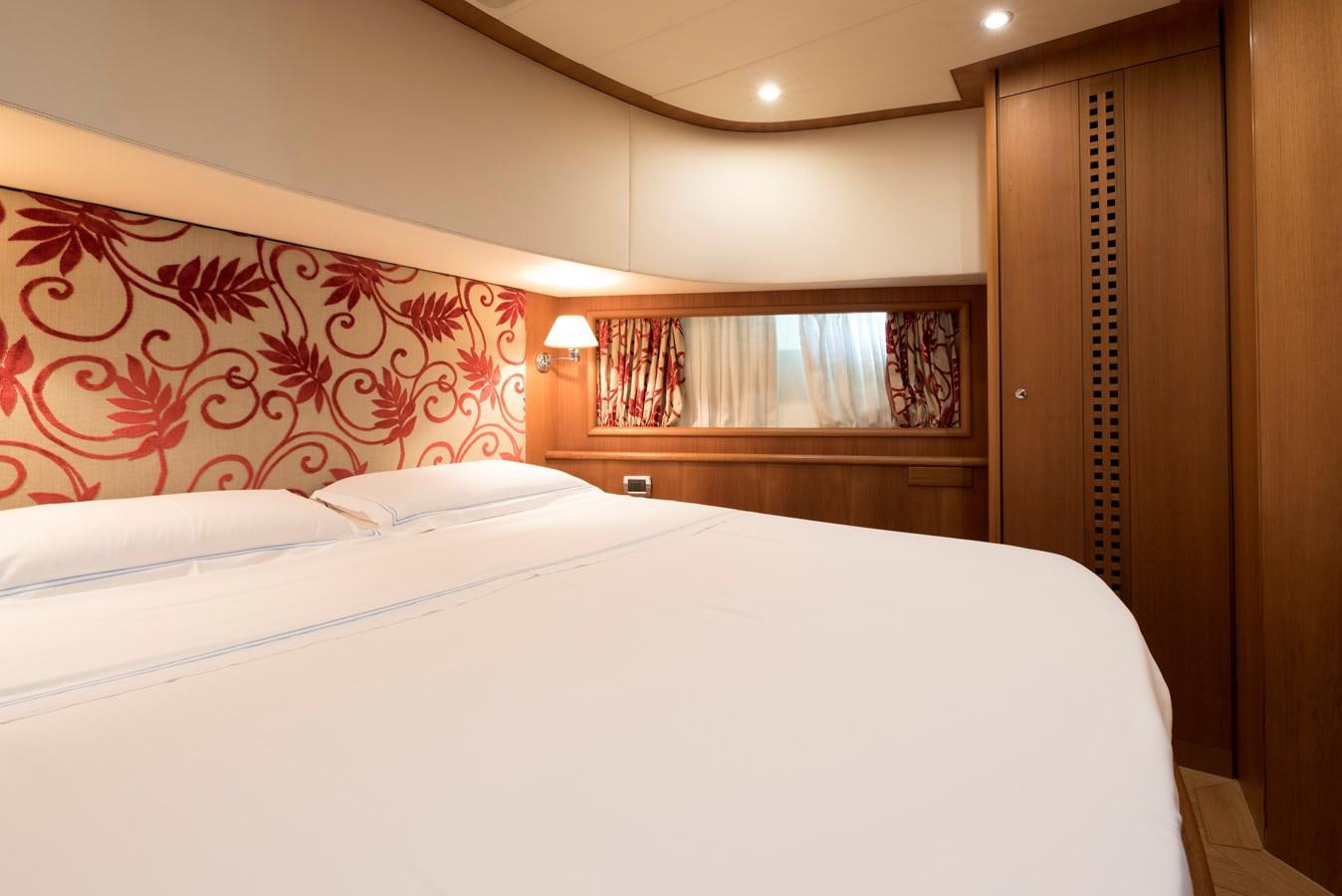 a bed with white sheets aboard ITACATOO Yacht for Sale