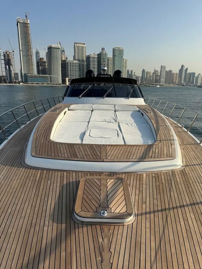 a boat on a deck with Scope Arena in the background aboard EL VIP ONE Yacht for Sale