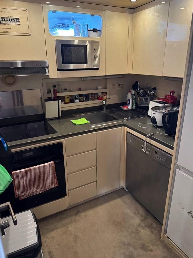 a kitchen with a microwave oven and a stove aboard EL VIP ONE Yacht for Sale