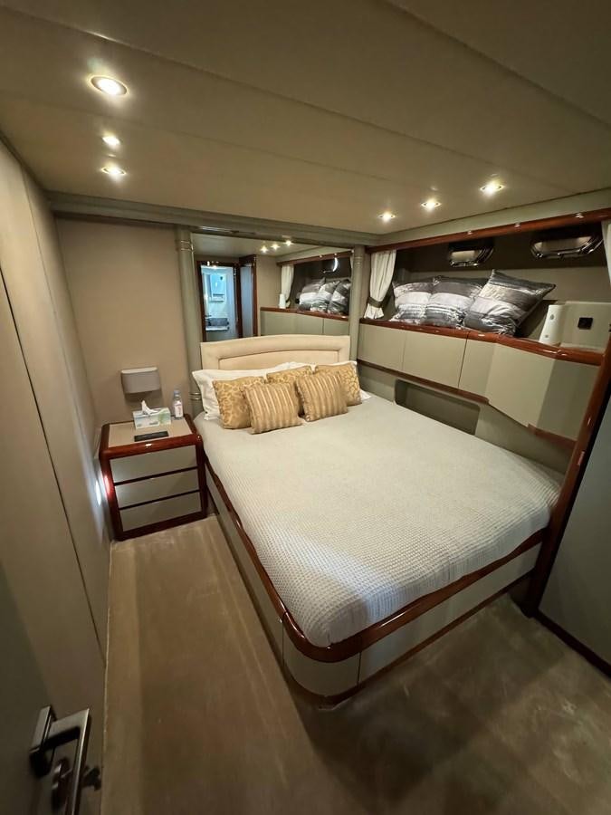 a bedroom with a bed and a mirror aboard EL VIP ONE Yacht for Sale