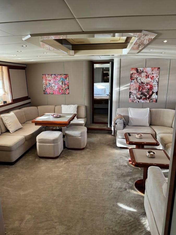 a living room with a couch and a table aboard EL VIP ONE Yacht for Sale