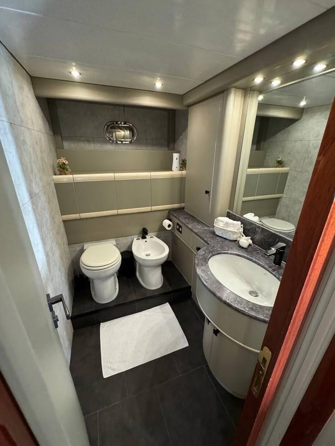a bathroom with a sink toilet and a mirror aboard EL VIP ONE Yacht for Sale