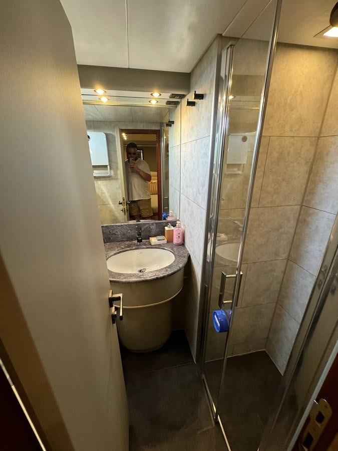 a person taking a selfie in a bathroom aboard EL VIP ONE Yacht for Sale