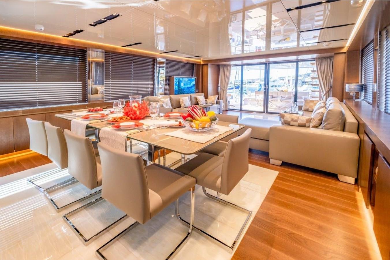 a large living room with a table and chairs aboard BACCARAT Yacht for Sale