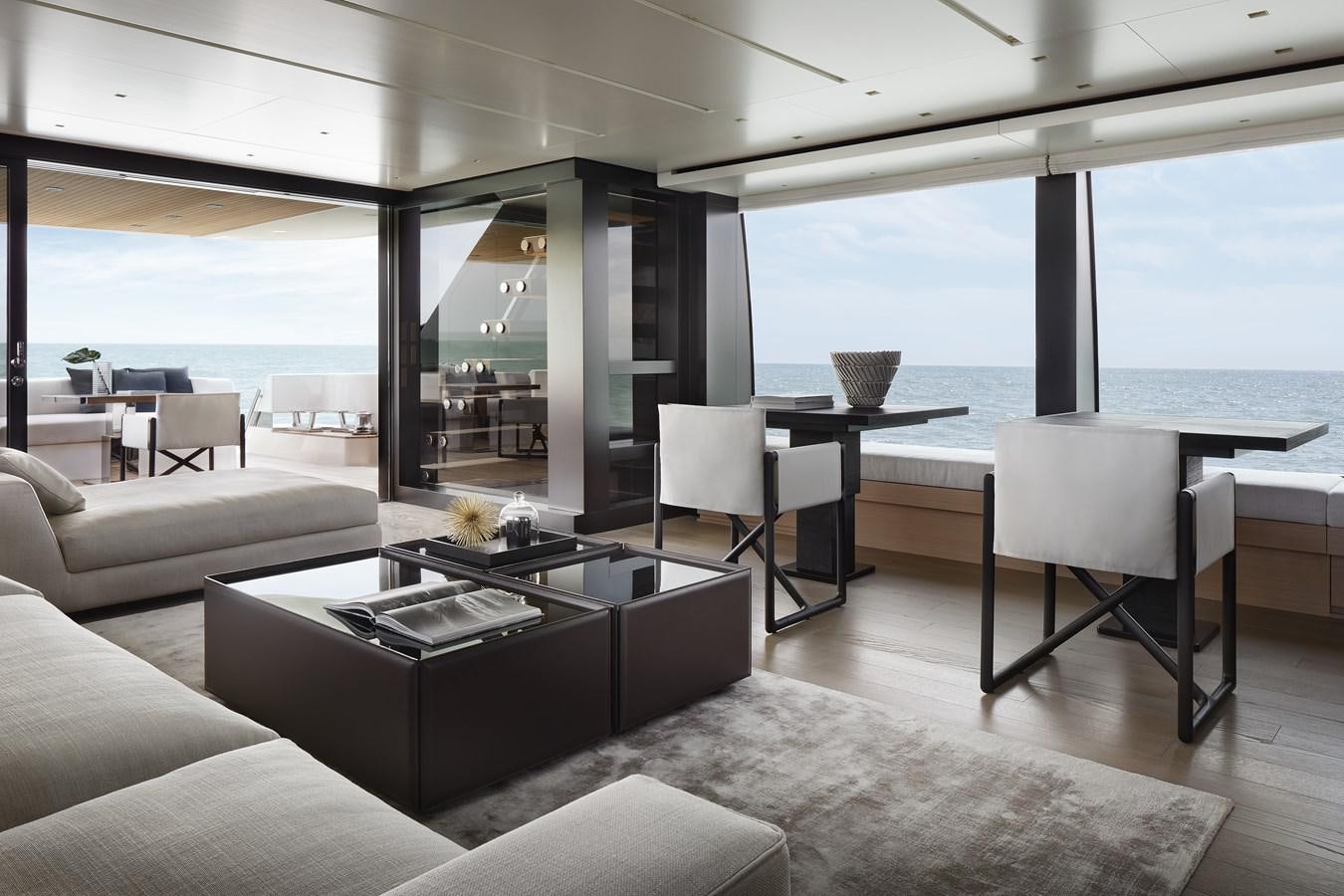 a living room with a large window overlooking the ocean aboard STRADODO Yacht for Sale
