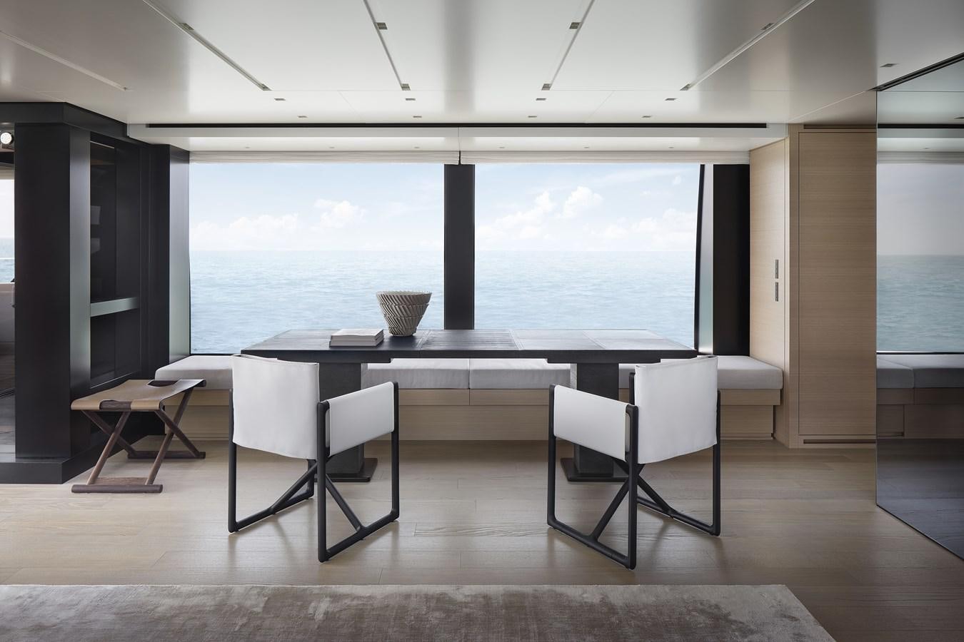 a room with a table and chairs aboard STRADODO Yacht for Sale