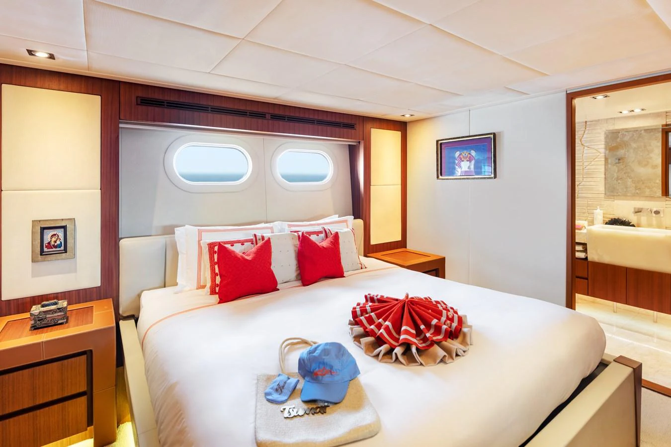 a bed with red pillows aboard CHAMPAGNE SEAS Yacht for Sale