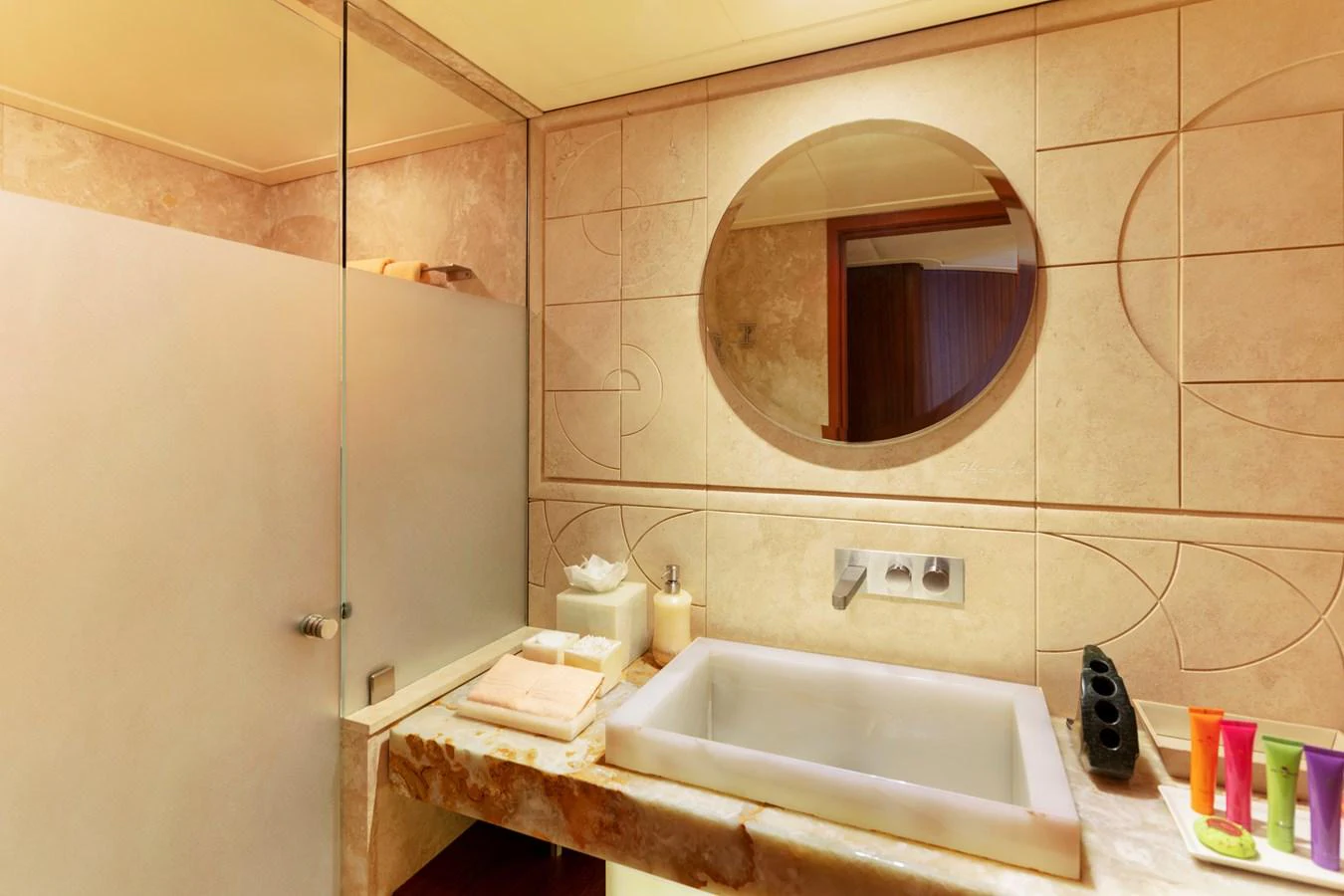 a bathroom with a round mirror aboard CHAMPAGNE SEAS Yacht for Sale