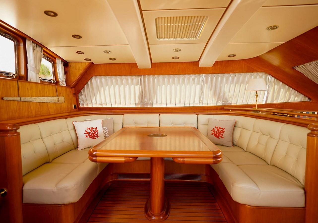 a living room with a couch and a table aboard IKARON Yacht for Sale