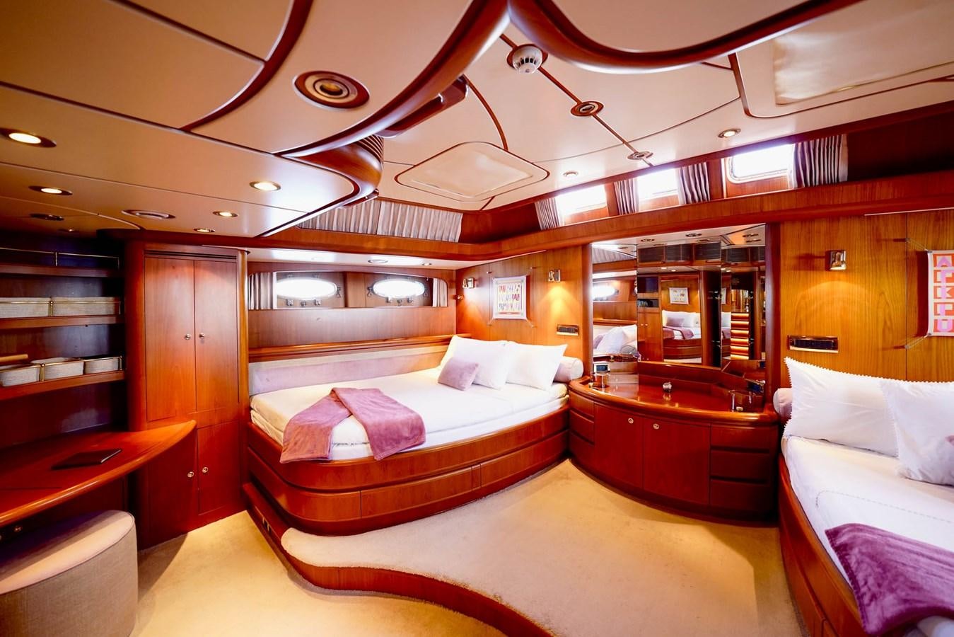 a room with a bed and a desk aboard IKARON Yacht for Sale