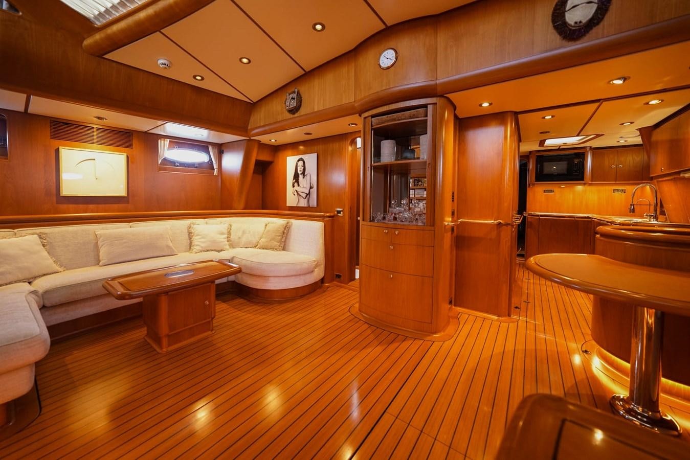 a large living room with a wood floor aboard IKARON Yacht for Sale