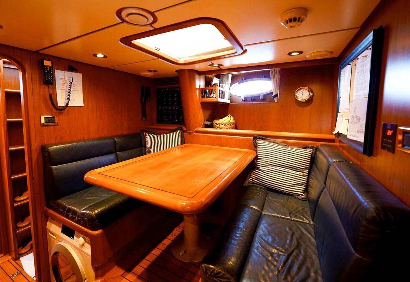 a room with leather couches and a table aboard IKARON Yacht for Sale