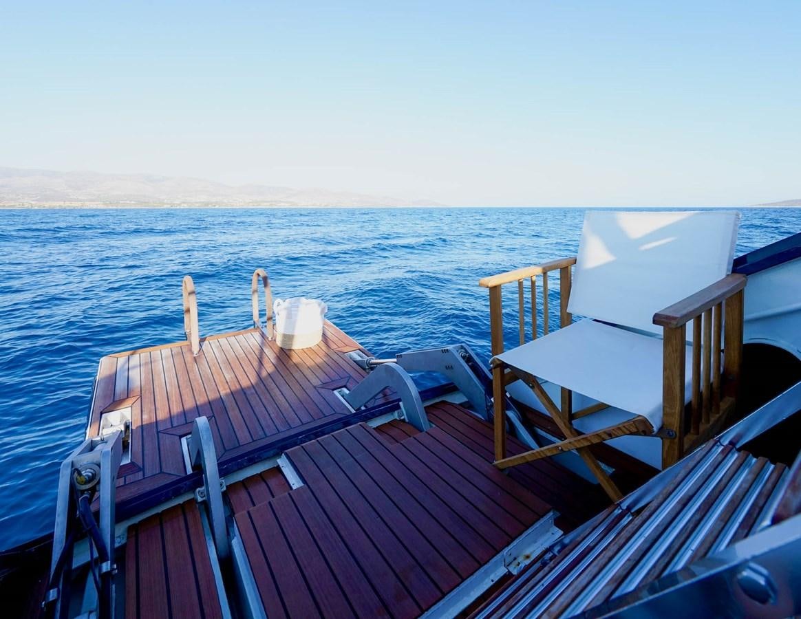 a deck with chairs on it by the water aboard IKARON Yacht for Sale