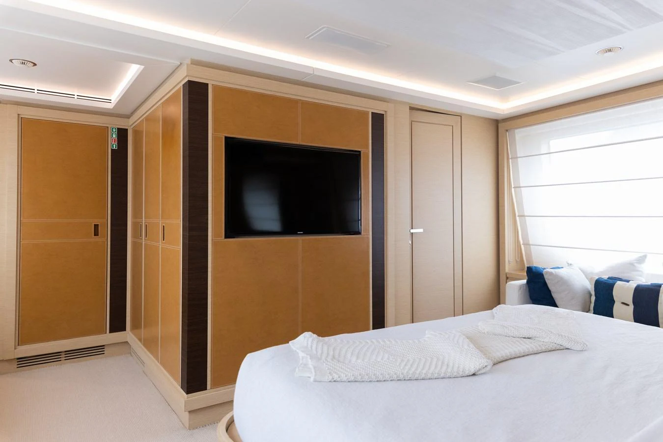 a room with a bed and a television aboard LIBERTY CALL Yacht for Sale
