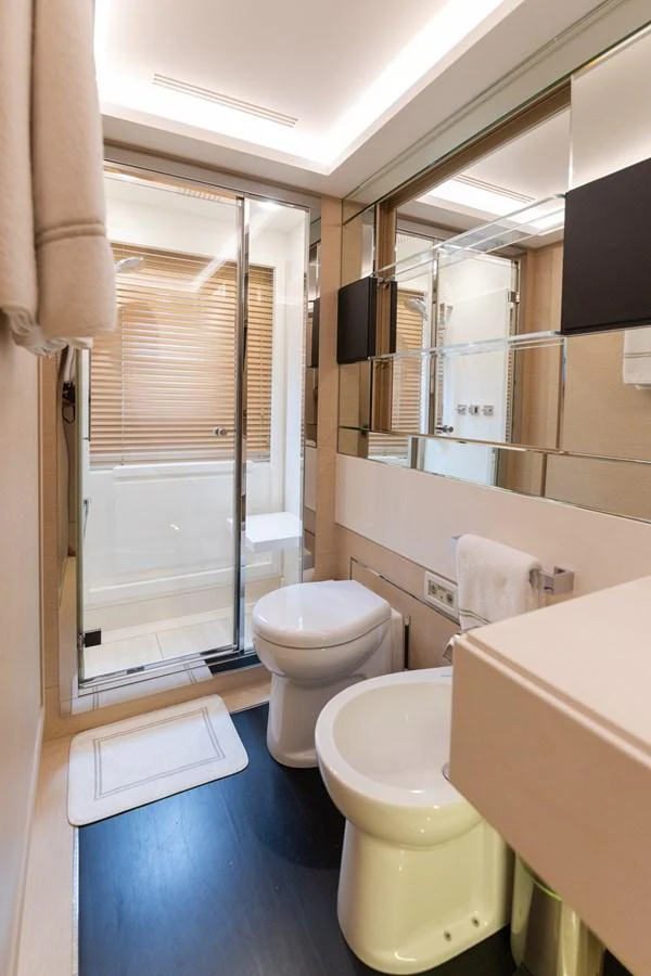a bathroom with a toilet and a bathtub aboard LIBERTY CALL Yacht for Sale