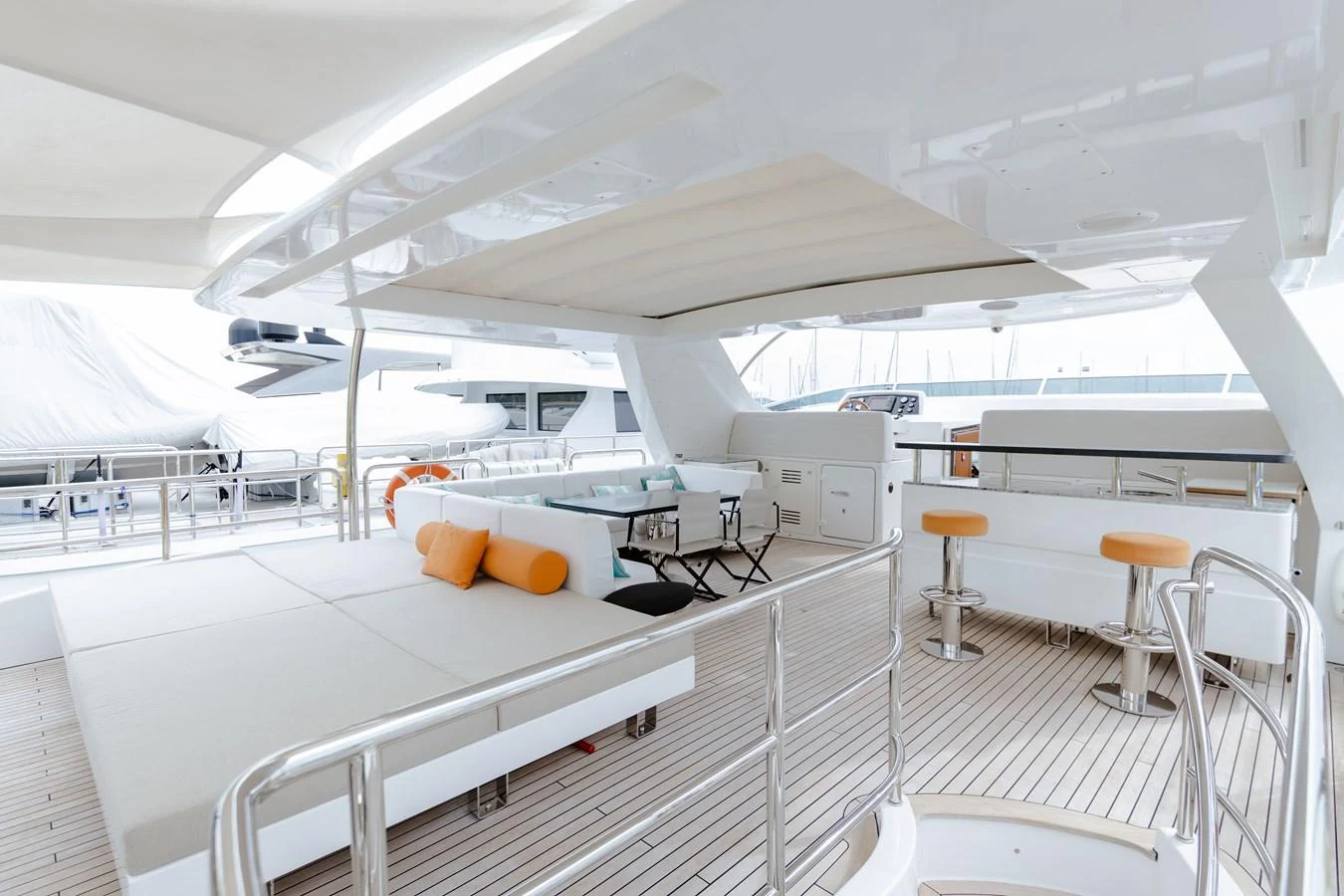 a white yacht with stools aboard LIBERTY CALL Yacht for Sale