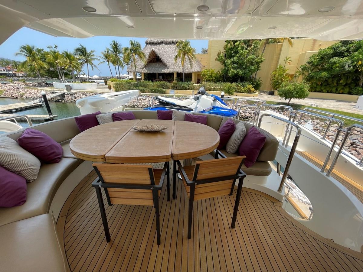 a table and chairs on a balcony aboard 2008 AZIMUT 75 FLY @ IXTAPA ZIHUATANEJO Yacht for Sale