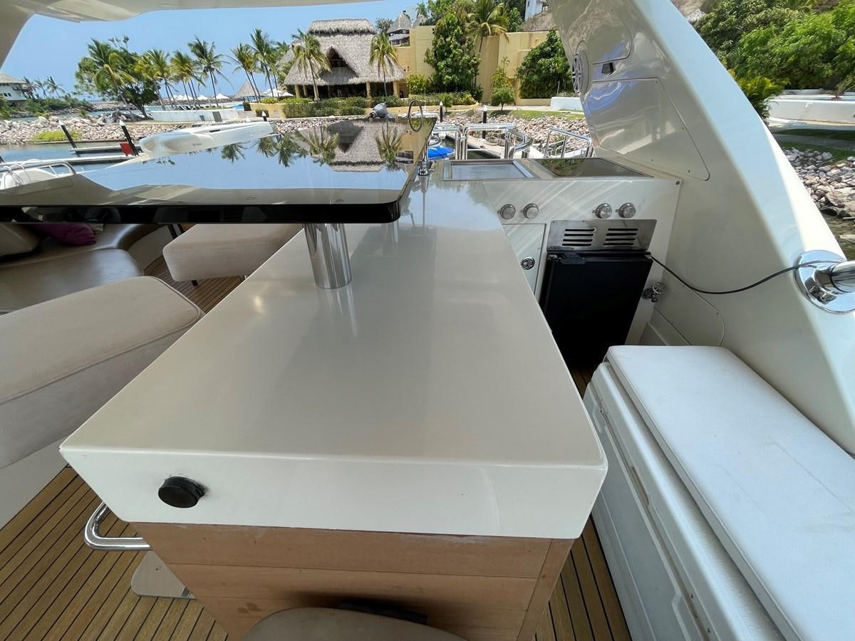 a white rectangular object on a wooden surface next to a white boat aboard 2008 AZIMUT 75 FLY @ IXTAPA ZIHUATANEJO Yacht for Sale