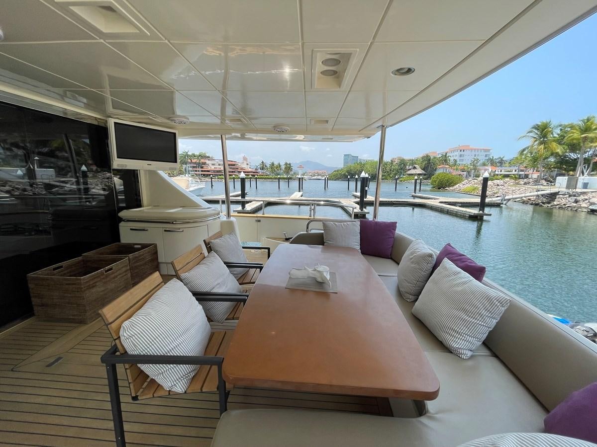 a boat with a table and chairs aboard 2008 AZIMUT 75 FLY @ IXTAPA ZIHUATANEJO Yacht for Sale