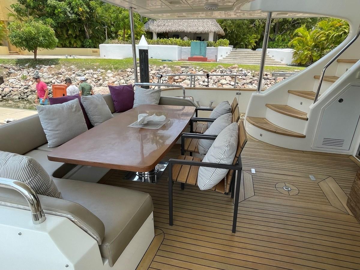 a table with chairs and a couch aboard 2008 AZIMUT 75 FLY @ IXTAPA ZIHUATANEJO Yacht for Sale