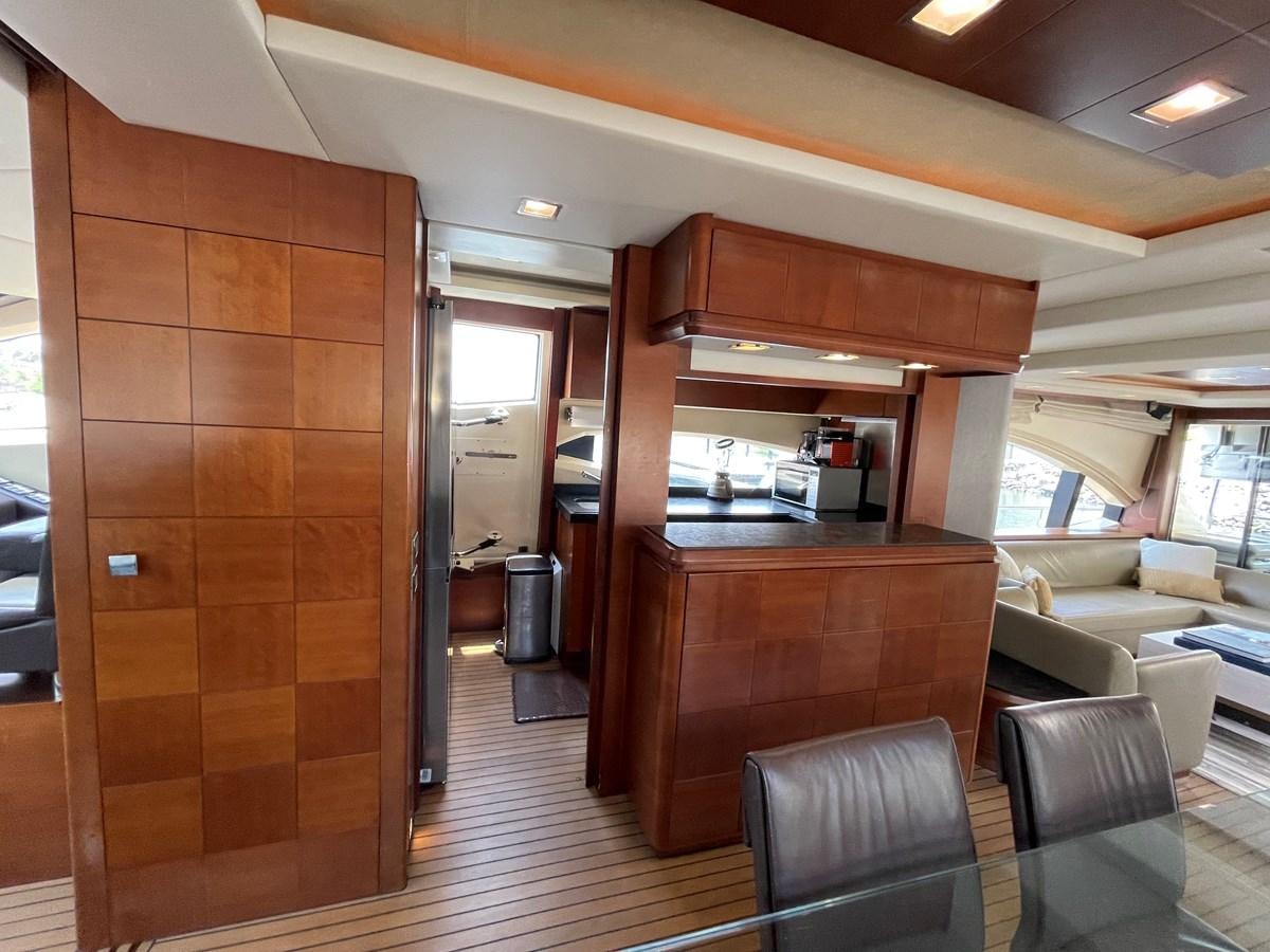 a room with a wood door and a wood cabinet with chairs and a wood door aboard 2008 AZIMUT 75 FLY @ IXTAPA ZIHUATANEJO Yacht for Sale