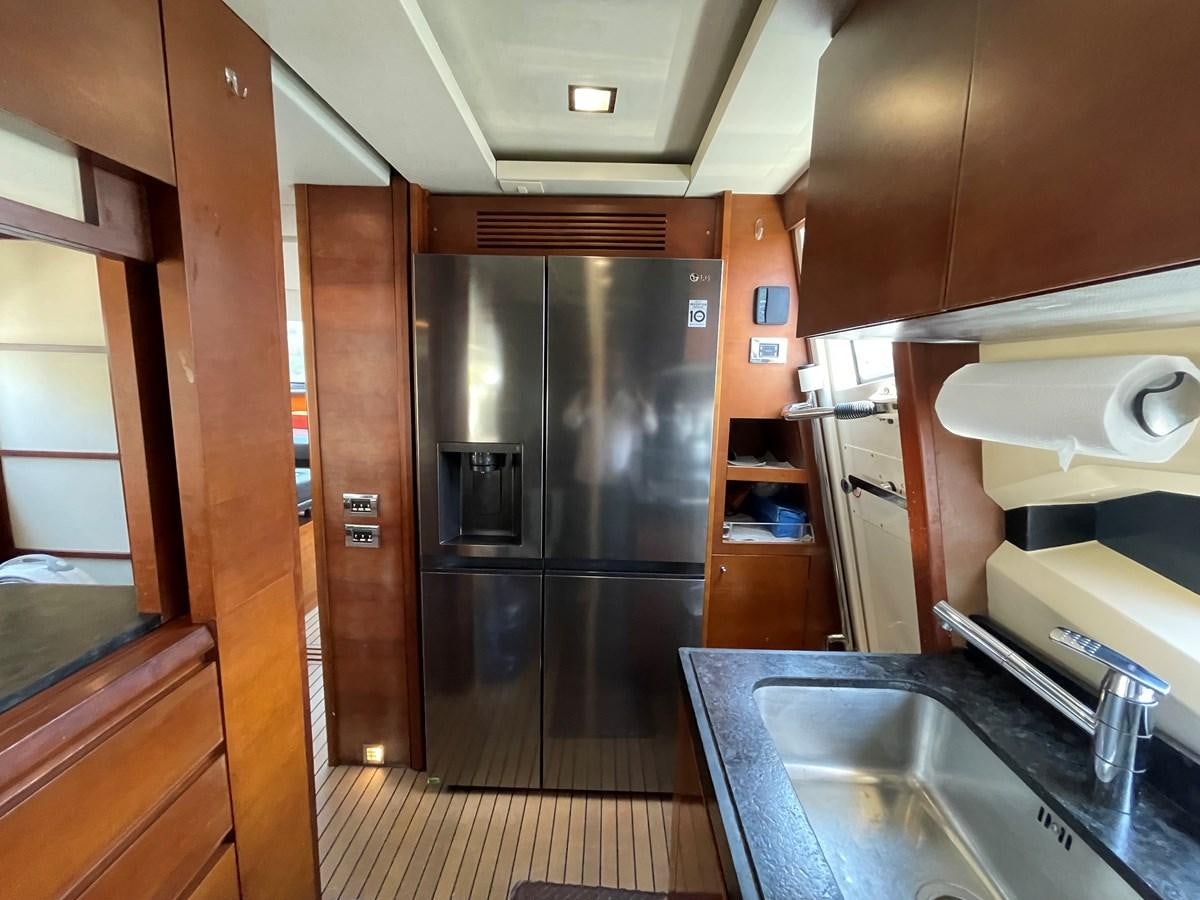 a kitchen with stainless steel appliances aboard 2008 AZIMUT 75 FLY @ IXTAPA ZIHUATANEJO Yacht for Sale