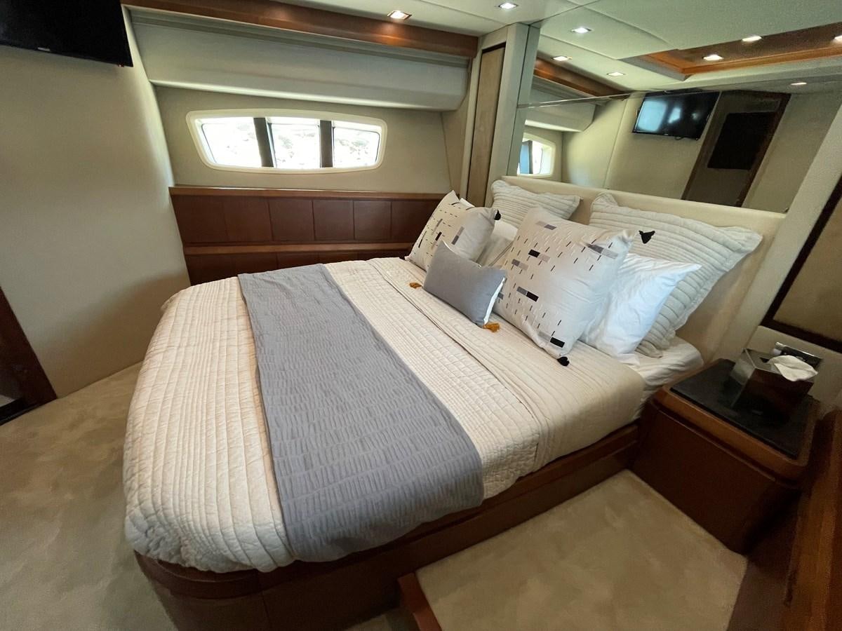 a room with a bed and a table aboard 2008 AZIMUT 75 FLY @ IXTAPA ZIHUATANEJO Yacht for Sale