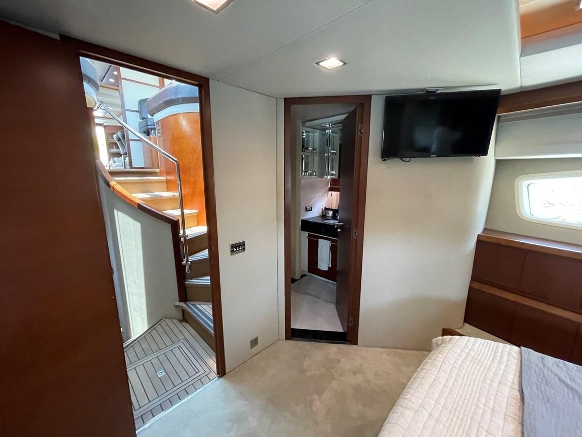 a bedroom with a bed and a television aboard 2008 AZIMUT 75 FLY @ IXTAPA ZIHUATANEJO Yacht for Sale